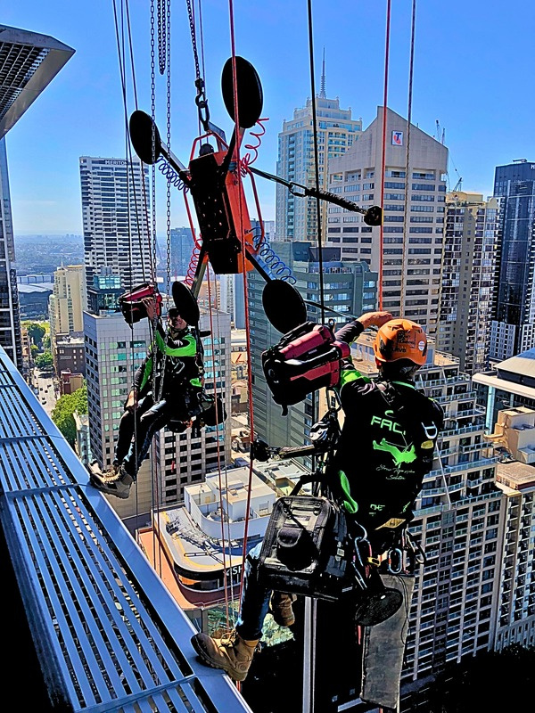 Apex Facades technicians suspended on ropes against a high-rise building